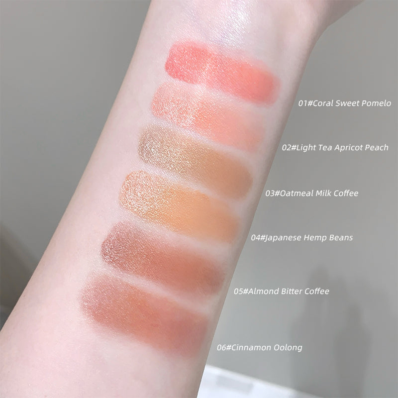 Lip color swatches on a person's arm with labeled shades.