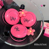 Pink makeup products with 'Gee Bear' branding on a clear glass surface, featuring '#BlackPink!' text.