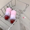 Two pink and red lip glosses on a metal rack with a neutral background