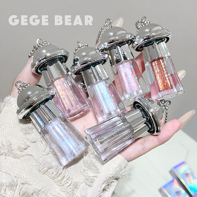 Set of glittery lip glosses held in a hand with 'GEGE BEAR' branding.