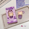Gege Bear lip balm with packaging on a textured surface