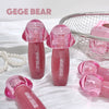 Pink GEGE BEAR products on a white surface with pearls and a basket in the background.