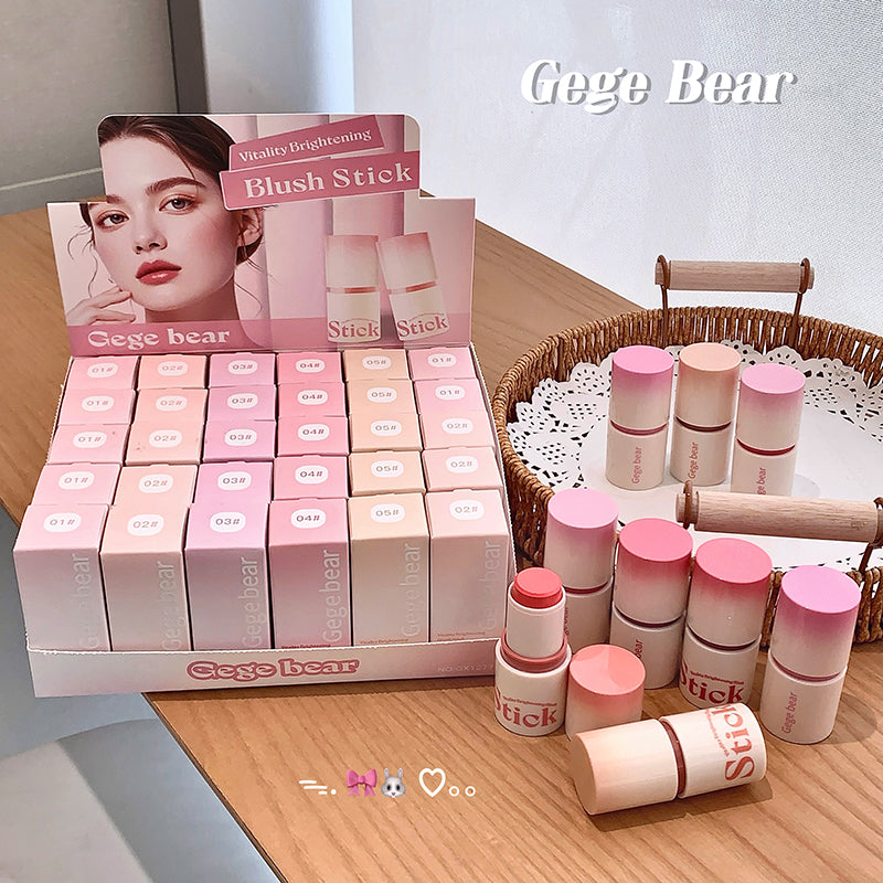 Display of Gege Bear blush sticks with packaging on a wooden surface.