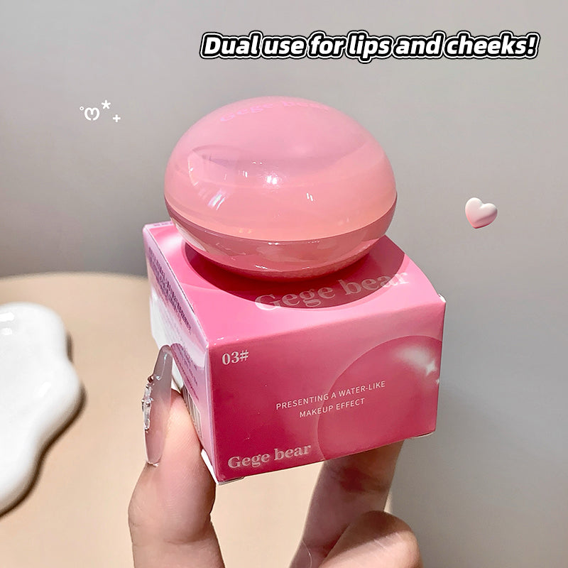 Pink cosmetic product with 'Gege bear' branding held by a hand against a neutral background.