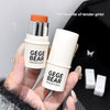 Two 'GEGE BEAR' highlight sticks held by a hand with a blurred background.