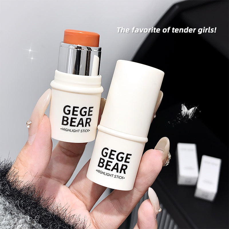 Two 'GEGE BEAR' highlight sticks held by a hand with a blurred background.