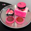 Makeup products with pink and brown shades on a metallic tray, featuring 'GEGE BEAR' branding.