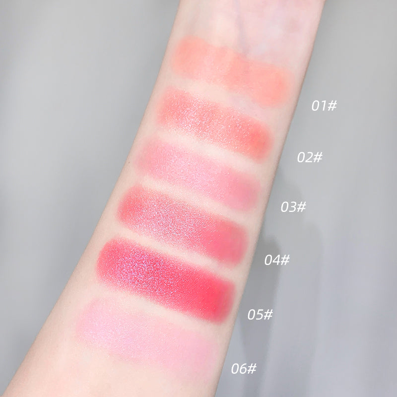 Color swatches of lipstick on a person's arm with labeled shades.