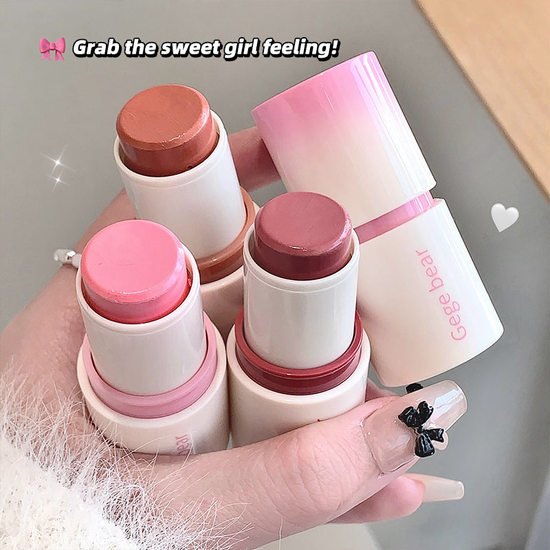 Hand holding four small cosmetic sticks with pink and white packaging, labeled 'Gege beat'.