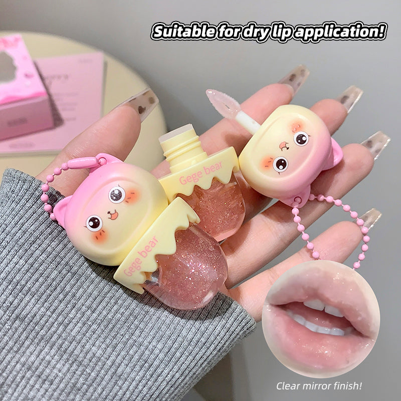Two lip balm products with cute designs held by a hand, one with a clear mirror finish.