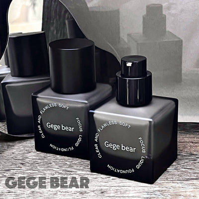 Black Gege Bear perfume bottles on a wooden surface with a blurred background