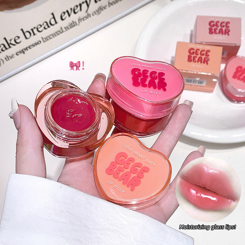 Three GECE BEAR lip jelly products held in a hand with a blurred background