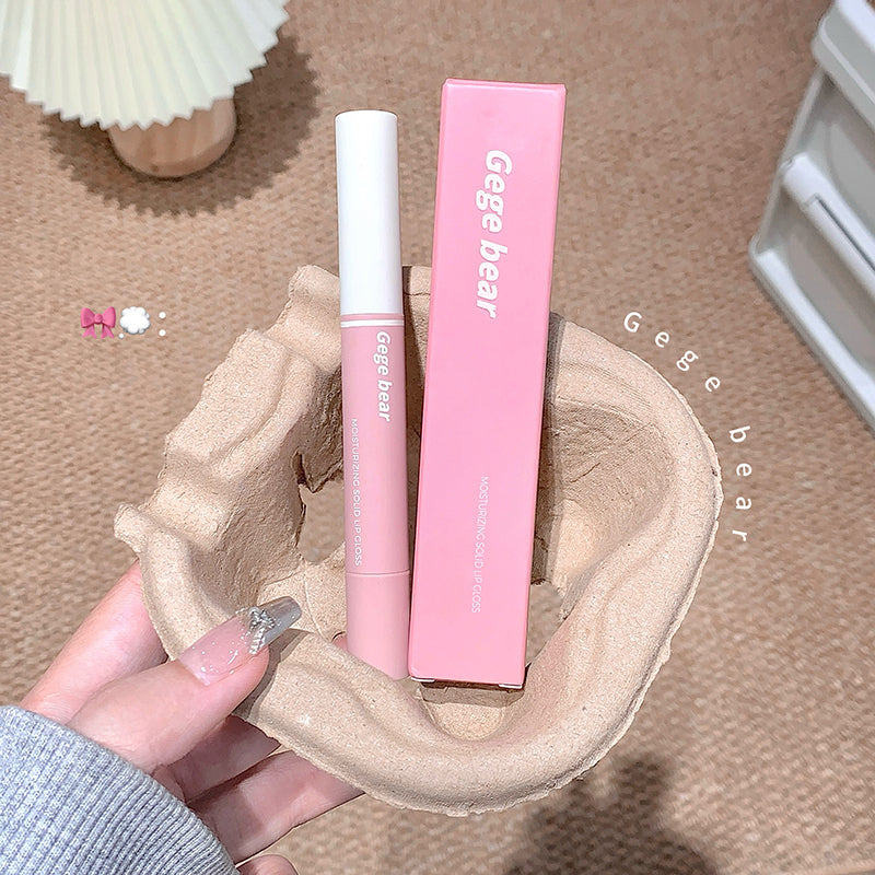 Pink lip gloss with packaging held by a hand on a textured surface, 'Gege bear' branding visible.