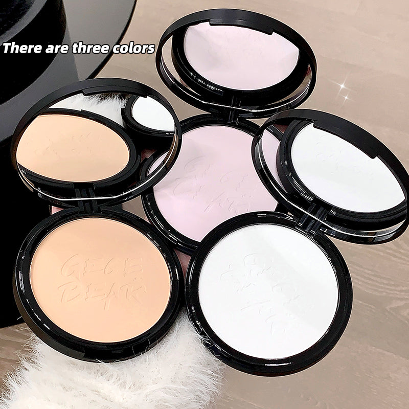 Compact powder cases in different colors on a neutral background
