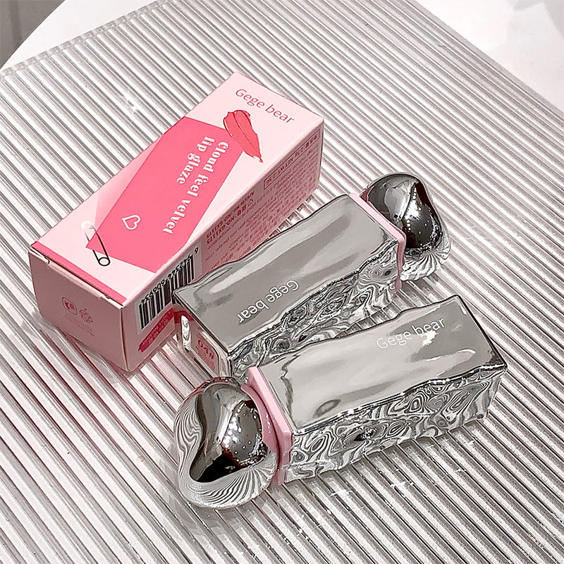 Silver and pink Gega bear product on a textured surface