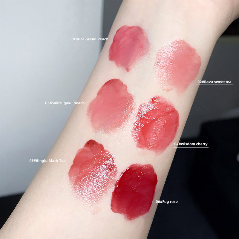Lipstick swatches on a person's arm with labeled colors