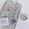 Set of bear-shaped makeup products on a tray with a mirror background
