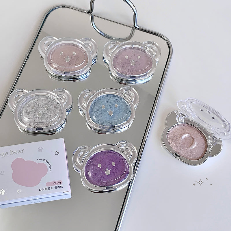 Set of bear-shaped makeup products on a tray with a mirror background