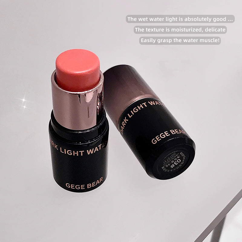 Lip balm with pink shade and black container labeled 'GEGE BEAR' on a light gray background.