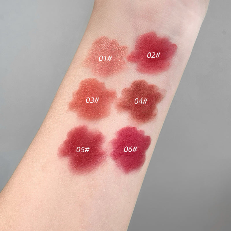 Lipstick swatches on a person's arm with color names labeled