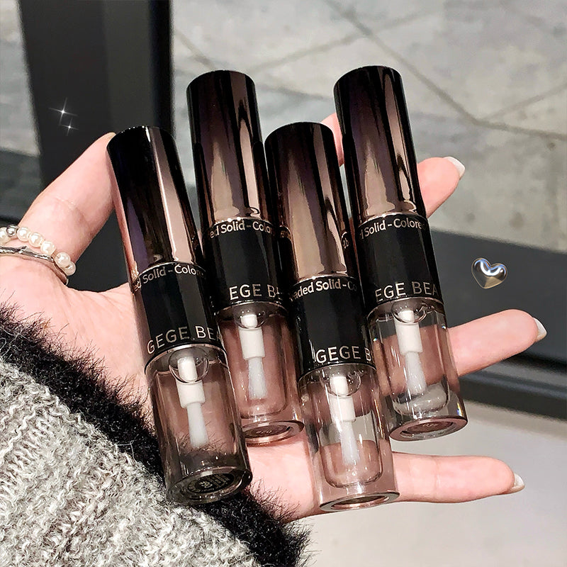 Hand holding four GEGE BEAUTY lip glosses with a blurred background