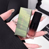 Hand holding a GEUGE BEAR cosmetic box and bottle