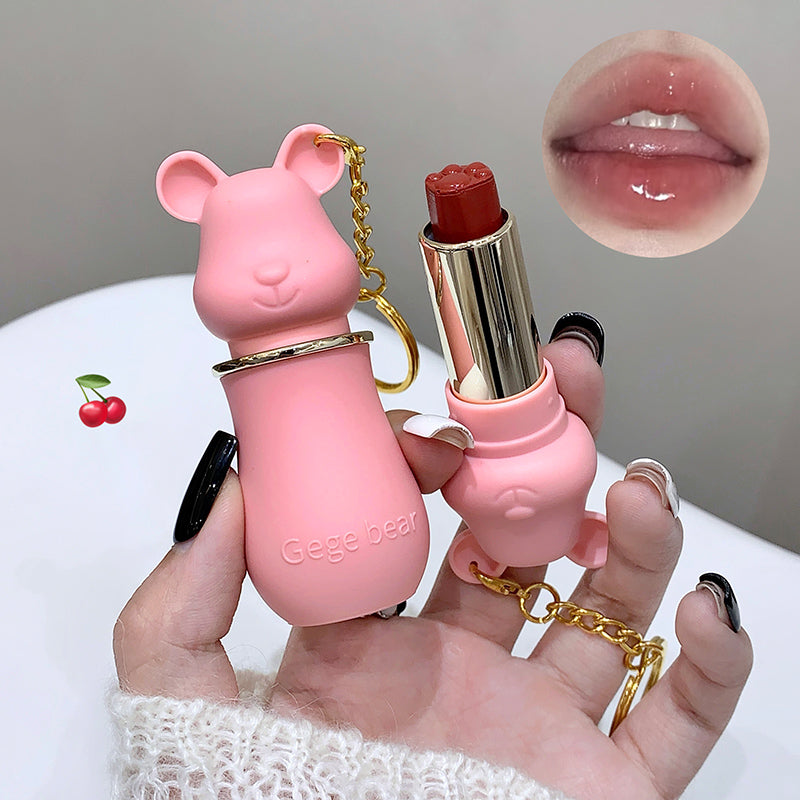 Pink bear-shaped lipstick case held by a hand with a close-up of lips and cherry emoji.
