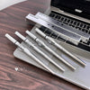 Set of GEGER BEAR pens on a wooden surface with a laptop in the background