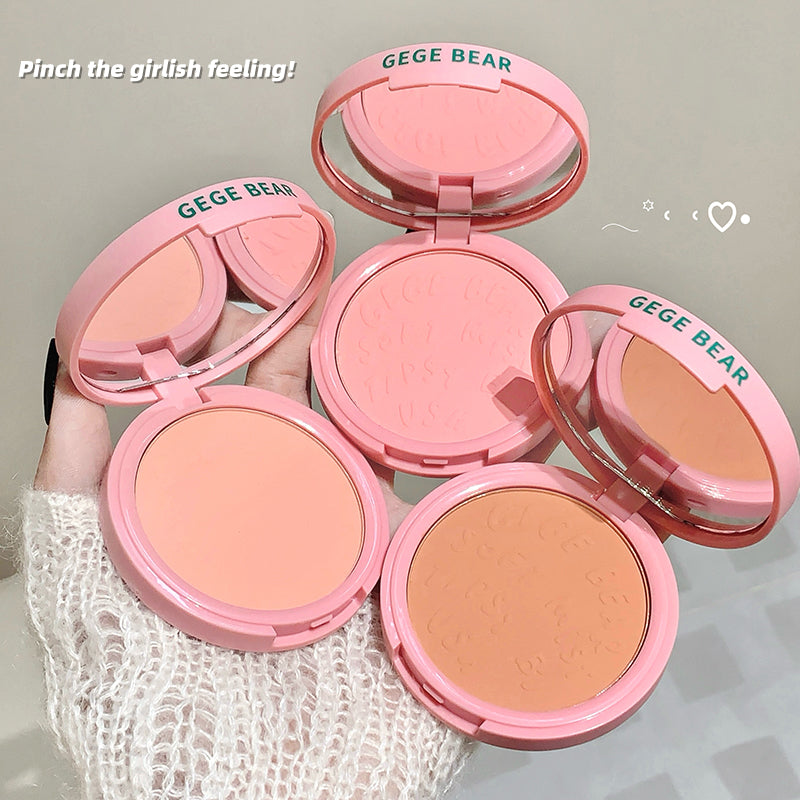 Pink blush compact with 'GEGE BEAR' branding held by a hand against a neutral background.