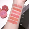 Lip balm swatches on a person's arm with labeled colors