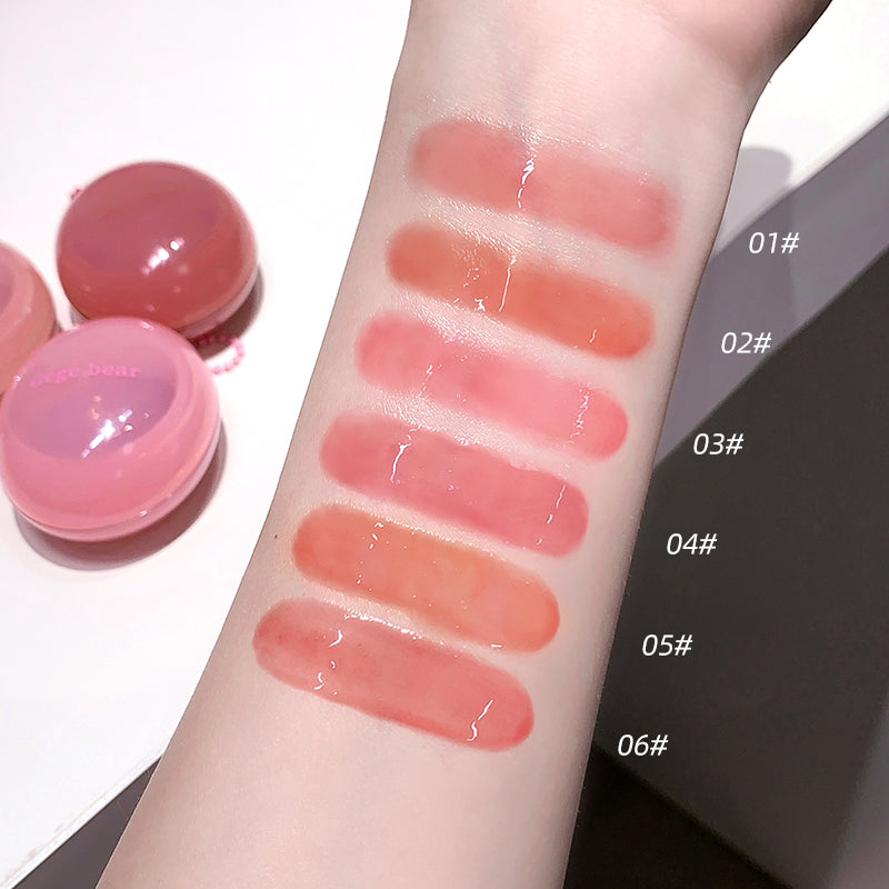 Lip balm swatches on a person's arm with labeled colors