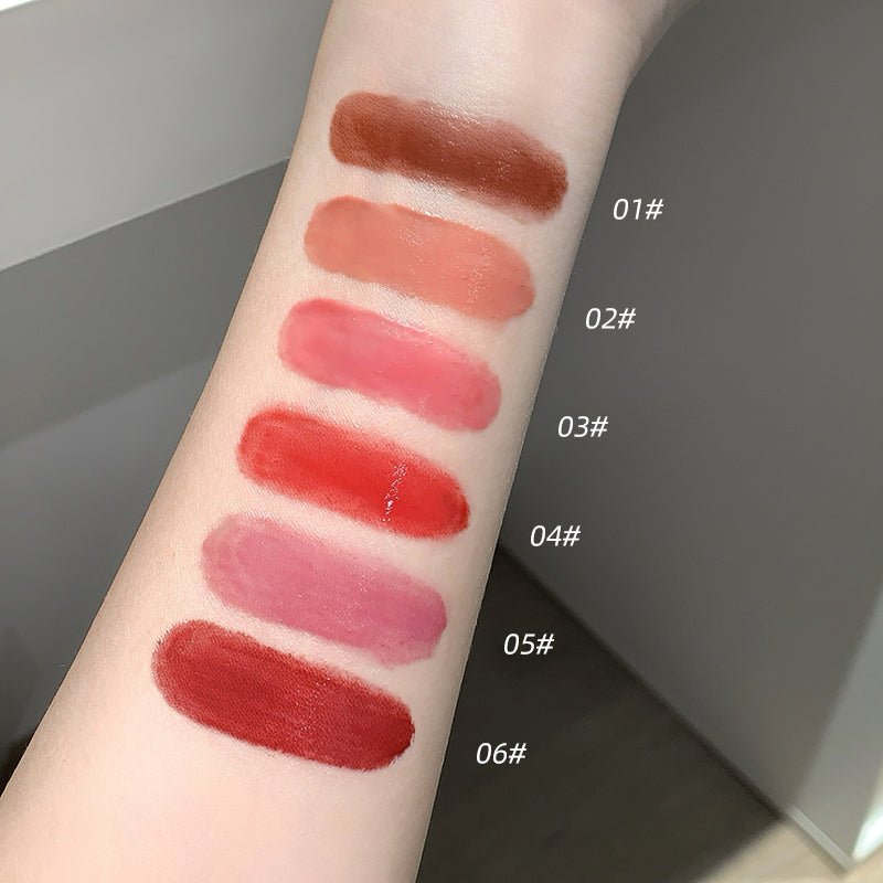 Lipstick swatches on a person's arm with color names labeled.