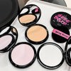 Makeup compacts with visible brand names on a white surface