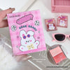 Pink GEGE BEAR product packaging held by a hand, with sunglasses and another product in the background.