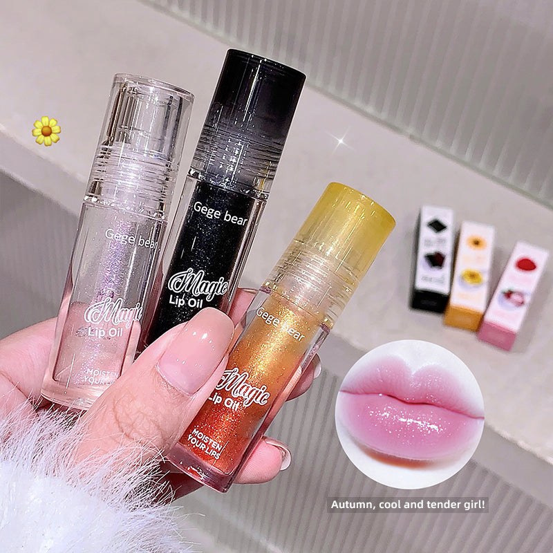 Three lip oil products held by a hand with an inset showing lips with a glossy finish.
