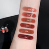 Lipstick swatches on a person's arm with color codes