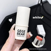 Hand holding a white highlight stick with 'GEGE BEAR' branding against a blurred background.