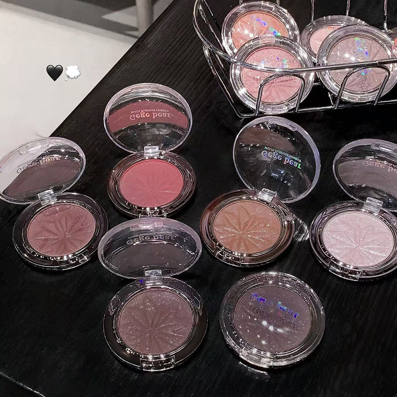 Makeup products with 'Coco Peru' branding on a dark surface.