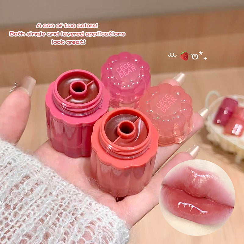 Two lip gloss containers with pink and red shades, held by a hand, on a neutral background.