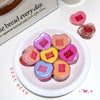 Colorful lip balm containers with 'GEGE BEAR' branding on a white plate.
