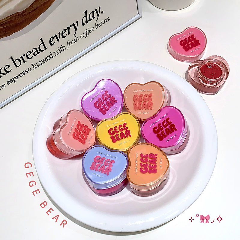 Colorful lip balm containers with 'GEGE BEAR' branding on a white plate.