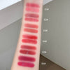 Lipstick swatches on a person's arm with color codes labeled.