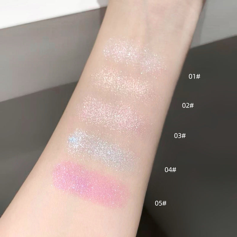 Color swatches of glittery makeup on a person's arm with labeled shades.