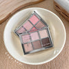 Makeup palette with pink and brown shades on a white plate, brand 'Gee Bear' visible.