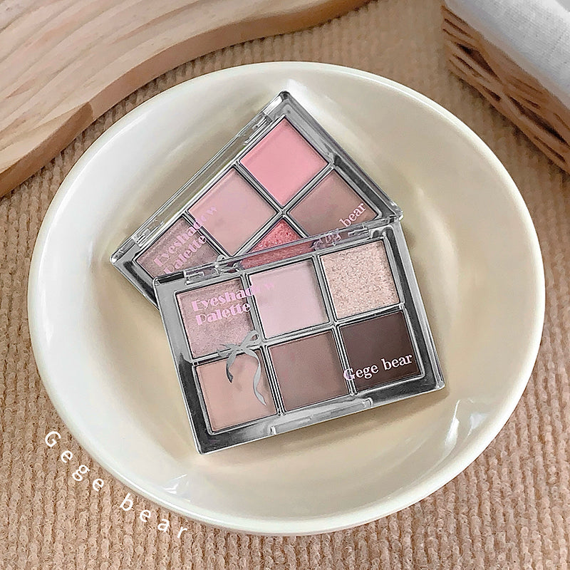 Makeup palette with pink and brown shades on a white plate, brand 'Gee Bear' visible.