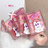 Four pink packaging cases with cartoon character designs on a white surface.