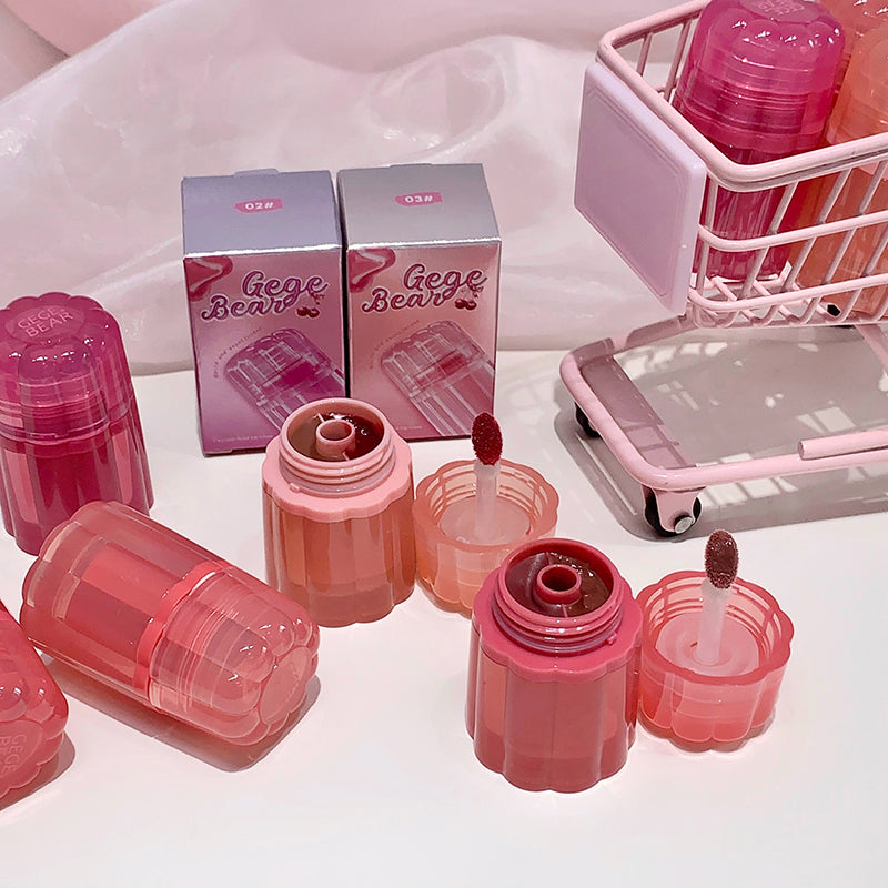 Pink cosmetic products with 'Gege Bear' packaging on a white surface.