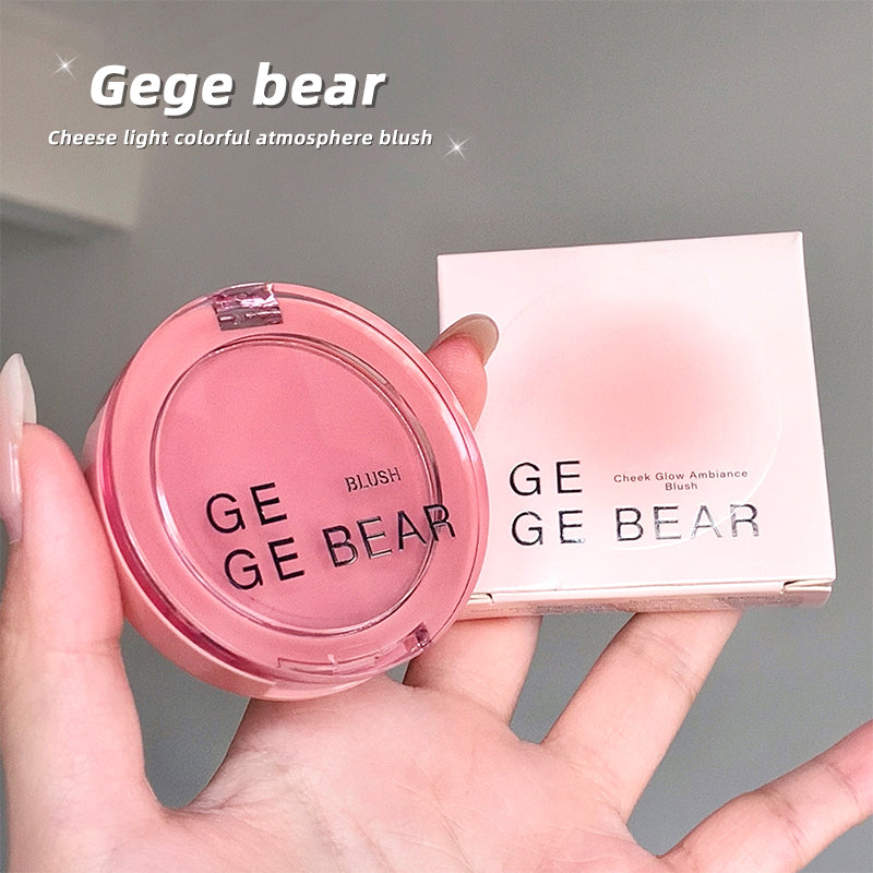 Pink blush compact with 'Gege Bear' branding held in a hand against a gray background