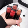 Four lip glosses from the brand 'Bege Bear' held in a hand against a white background.