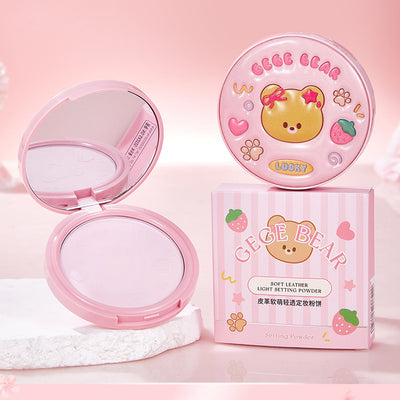 Pink makeup compact with bear design on a pink background